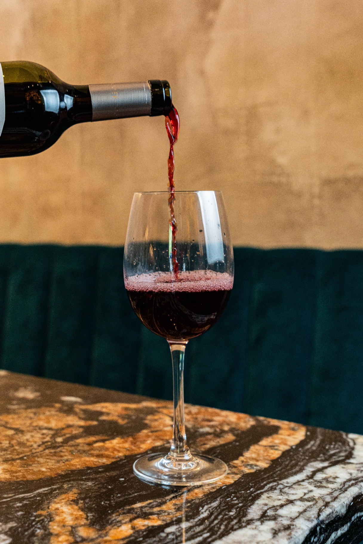 A glass of red wine served on marble