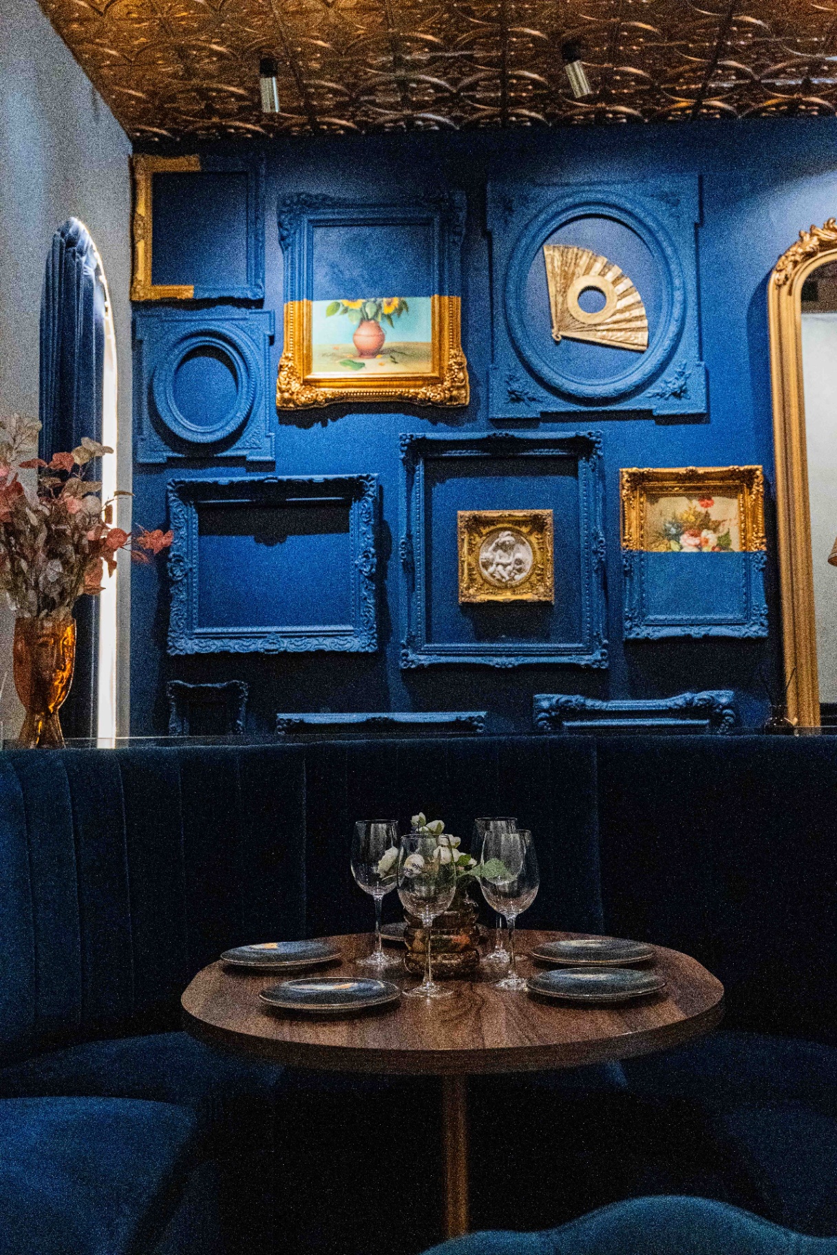 Dining room with framed walls and brass ceiling